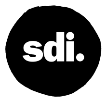 logo of lowercase letters "sdi." in a black circle 