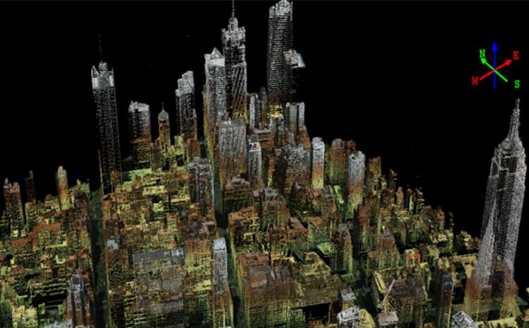 A digital representation of a city is seen from overhead on a black background, with a compass in the upper right corner of the image.