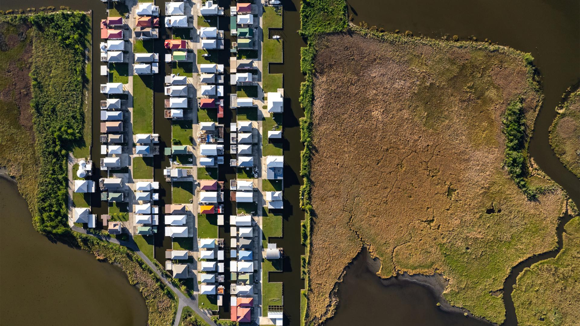 A series of homes on land surrounded by water.